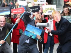 Clive Lewis (centre) adopts a pose of mock terror as activists impersonating Dominic Cummings and Boris Johnson take part in a ‘whack a mole’ photo call outside BBC New Broadcasting House in London (Jonathan Brady/PA)