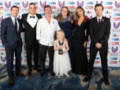 Ella Chadwick (front) wins Child of Courage award from (left to right) Dermot O’Leary, Robbie Williams Simon Cowell, Karen Chadwick (Ella’s mum), Ayda Field and Louis Tomlinson during the Pride Of Britain Awards 2018 (Steve Parsons/PA)