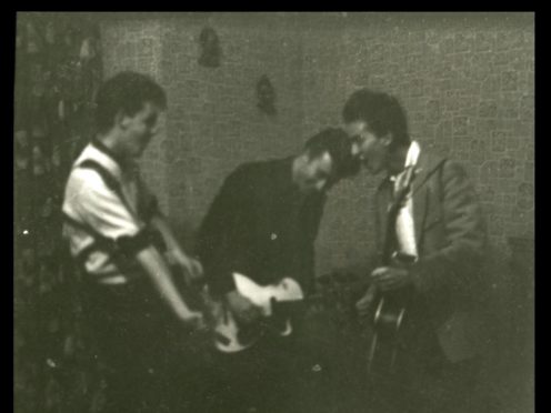 Paul McCartney, left, John Lennon, centre, and George Harrison, right, play their guitars as the Quarrymen (Tracks Ltd/PA)