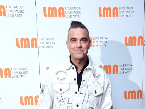 Robbie Williams said he was threatened with being beheaded while working for a charity in Haiti following the 2010 earthquake (Ian West/PA)