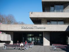 The National Theatre, on the South Bank, in London, is wrapped in tape at the launch of the #MissingLiveTheatre campaign (Dominic Lipinski/PA)