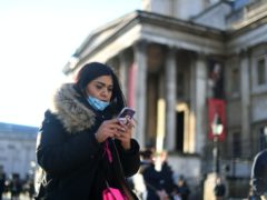 A woman wearing a face mask outside the National Gallery (Victoria Jones/PA)