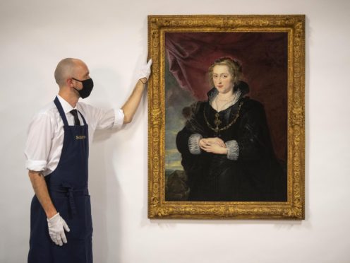 A Sotheby’s technician with a rediscovered Rubens portrait (Victoria Jones/PA)
