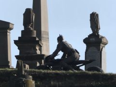 A man dressed as Batman during filming at the Glasgow Necropolis cemetery (Andrew Milligan/PA)
