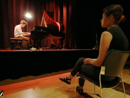 Pianist Elliot Galvin performs to a limited audience during the launch of Kings Place London’s one-on-one Culture Clinics, where solo spectators watch from a safe social distance (Jonathan Brady/PA)