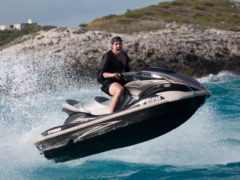 Billy McFarland rides a jet ski(Netflix/PA)