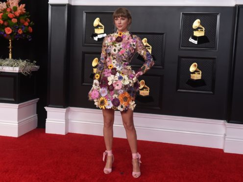 Taylor Swift delivered a rustic performance against a backdrop of a log cabin and woodland during the Grammy Awards. (Jordan Strauss/Invision/AP)