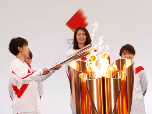 The torch is lit by a member of Japan’s women’s national soccer team “Nadeshiko Japan” during the Tokyo 2020 Olympic Torch Relay Grand Start in Naraha, Fukushima prefecture, northeastern Japan, Thursday, March 25, 2021. The torch relay for the postponed Tokyo Olympics began its 121-day journey across Japan on Thursday and is headed toward the opening ceremony in Tokyo on July 23. (Kim Kyung-Hoon/Pool Photo via AP)