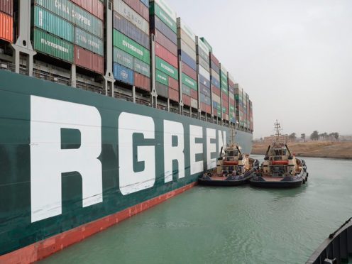 Two tugboats next to the Ever Given (Suez Canal Authority/AP)