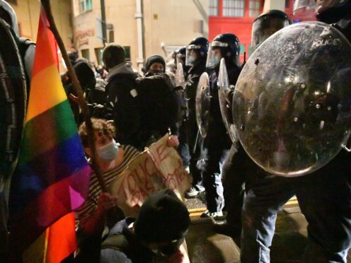 Protesters sit in front of a police line during the ‘Kill The Bill’ protest against The Police, Crime, Sentencing and Courts Bill in Bristol (Ben Birchall/PA)