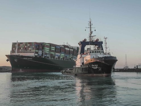 In this photo released by Suez Canal Authority, the Ever Given, a Panama-flagged cargo ship is pulled by one of the Suez Canal tugboats, in the Suez Canal, Egypt, Monday, March 29, 2021. Engineers on Monday “partially refloated ” the colossal container ship that continues to block traffic through the Suez Canal, authorities said, without providing further details about when the vessel would be set free. (Suez Canal Authority via AP)