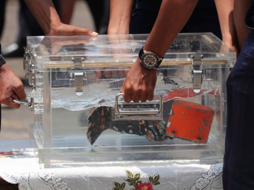 Investigators carry a box containing the cockpit voice recorder (AP)