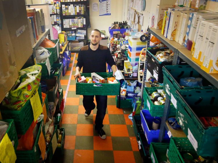 A new report sets out in ‘stark terms’ the scale of poverty in Scotland (Danny Lawson/PA)