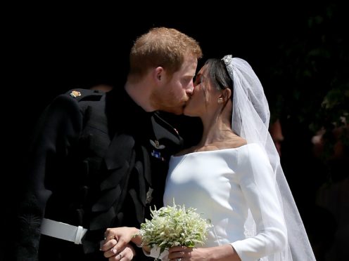 Prince Harry and Meghan Markle kiss outside St George’s Chapel in Windsor Castle after their wedding (Jane Barlow/PA)