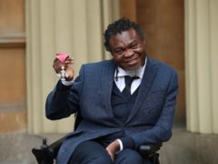 Yinka Shonibare holds his CBE for services to art (Yui Mok/PA)