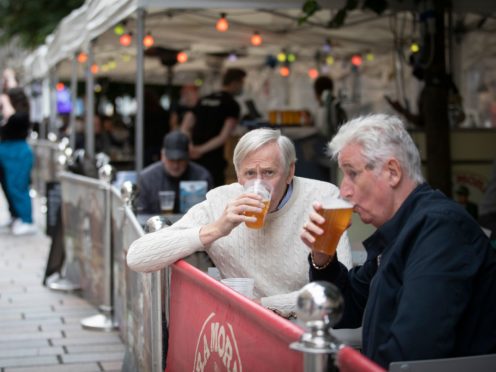 Members of the public enjoy their first drink in the beer garden at the Bier Halle, Glasgow (PA)