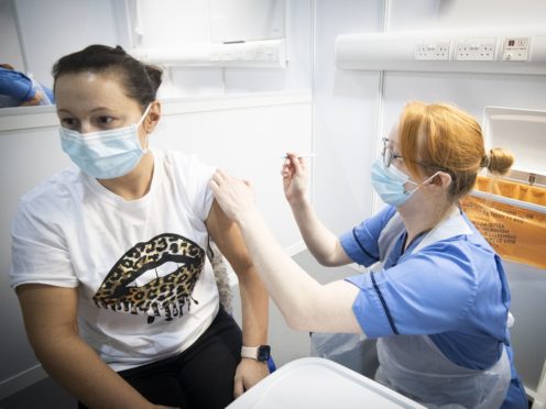 A coronavirus vaccine is administered (Jane Barlow/PA)