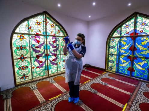 Practice nurse Hannah Currie, 25, prepares a dose of the AstraZeneca vaccine at Bradford Central Mosque, which is doubling as a community Covid-19 vaccination centre (Peter Byrne/PA)