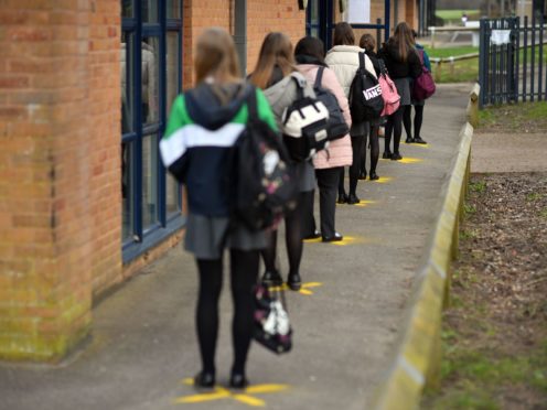 File photo of pupils queuing to take a lateral flow test at Archway School in Stroud in Gloucestershire (Ben Birchall/PA)