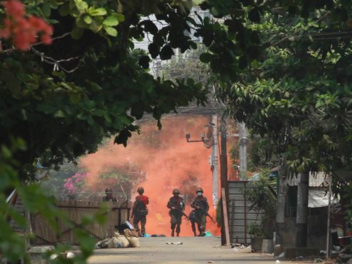 Soldiers walk towards anti-coup protesters in Yangon (AP)