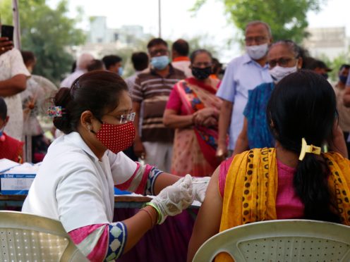 A health worker administers a vaccine in India (Ajit Solanki/AP)