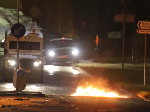 The PSNI on North Road in Carrickfergus near Belfast following sporadic outbursts of disorder. Picture date: Sunday April 4, 2021.