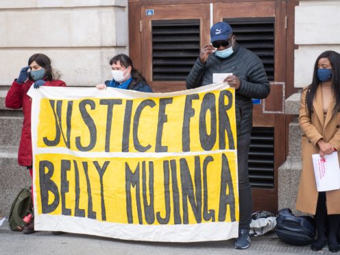 Lusamba Katalay (third from left), the husband of Belly Mujinga, joins activists at a vigil at Victoria station (Dominic Lipinski/PA)
