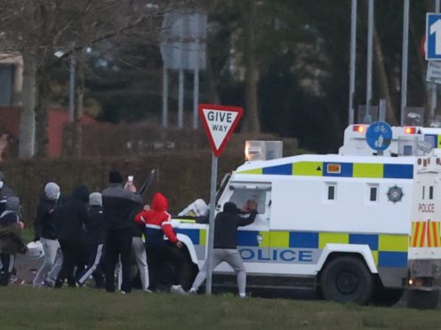 Youths attack a PSNI vehicle in the Nationalist area of Shantallow (Liam McBurney/PA)