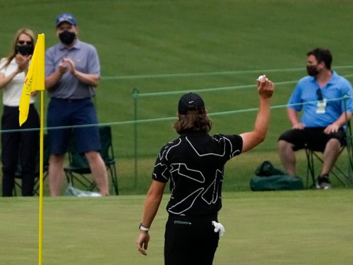 Tommy Fleetwood holds up his ball after a hole-in-one on the16th hole during the first round of the Masters (Gregory Bull/AP)