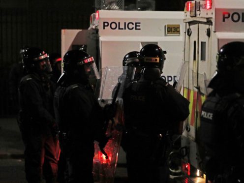 PSNI officers on North Queen Street in Belfast (PA)
