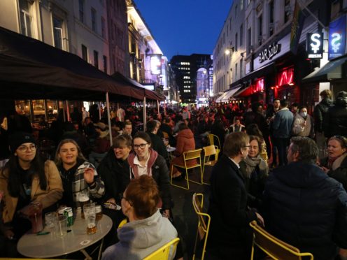 People gather for drinks and food in Old Compton Street, Soho, central London (Jonathan Brady/PA)