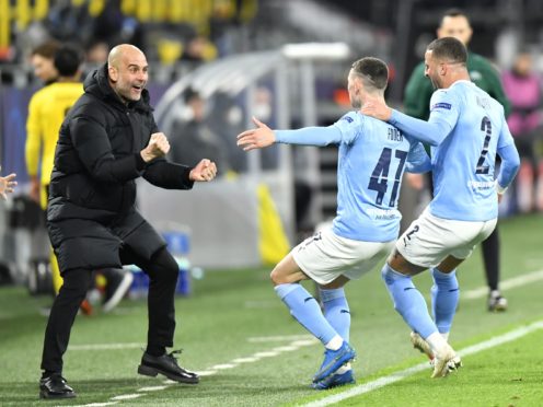 Manchester City manager Pep Guardiola celebrates with goal scorer Phil Foden and Kyle Walker, right (PA Wire via DPA)