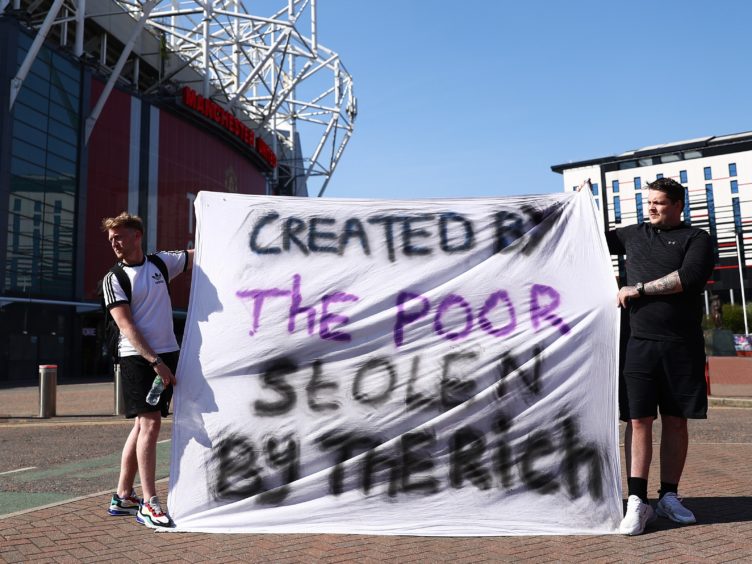Football fans opposing the European Super League proposals outside Old Trafford in Manchester (Tim Markland/PA)
