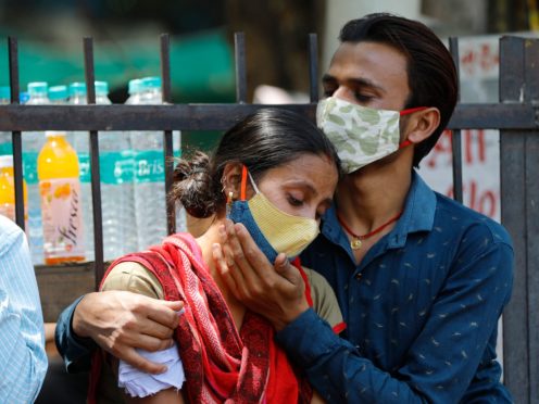 Relatives of a Covid-19 victim outside the Lok Nayak Jaiprakash Narayan Covid-19 hospital in New Delhi, India (AP)