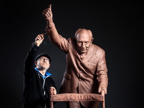 Andrian Melka puts the finishing touches to his clay statue of Captain Sir Tom Moore at his home studio near York (Danny Lawson/PA)