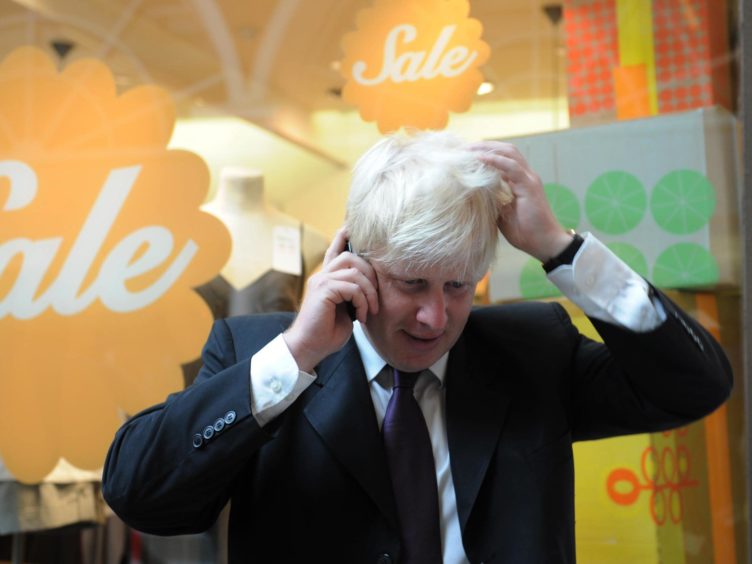 Boris Johnson on the phone while London mayor (Stefan Rousseau/PA)