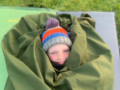 Archie Tunstill, aged eight, is to spend 100 nights sleeping in a bivvy bag in his garden in Suffolk for the Captain Tom 100 (Poppy Tunstill/PA)