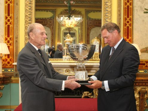 The Duke of Edinburgh presents the Aero Club Cup to David Hempleman-Adams, at a reception at Buckingham Palace, in central London in 2011 (Dominic Lipinski/PA)