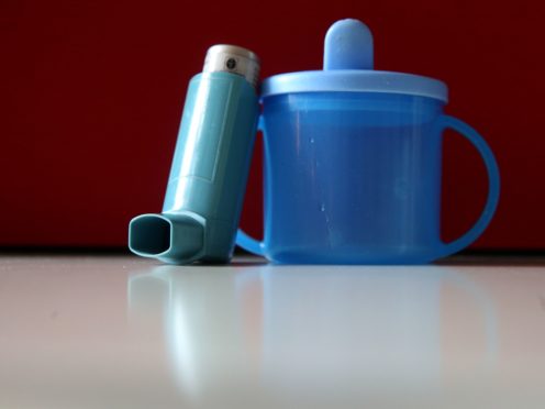 An inhaler used for treating asthma sits beside a child’s cup (Brian Lawless/PA)