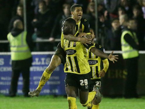 Ayo Obileye, bottom, celebrates scoring for Dagenham & Redbridge (Steve Paston/PA)