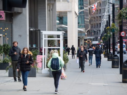 People pass shops and offices on a street in central London (Dominic Lipinski/PA)