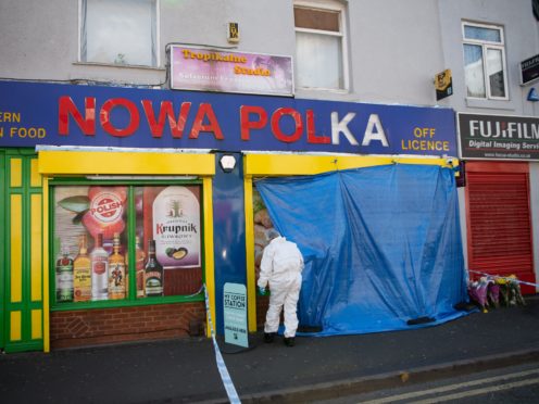 Forensic officers enter a shop on Waterloo Road, Smethwick (PA)