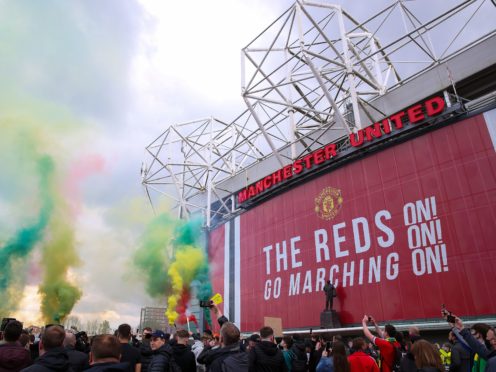 Manchester United fans let off flares as they protest against the Glazer family (Barrington Coombs/PA)