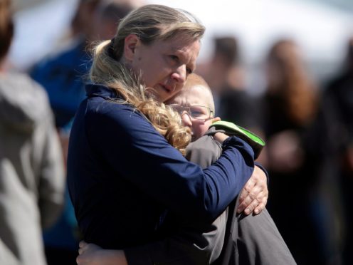 People embrace after a school shooting at Rigby Middle School (John Roark/The Idaho Post-Register via AP)