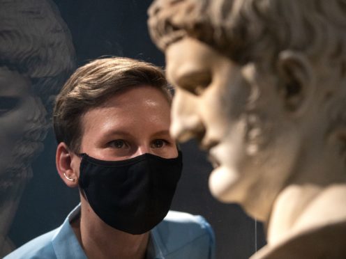 Project curator Francesca Bologna inspects a marble bust of Nero (Andrew Matthews/PA)