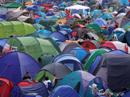 Festivalgoers relax at the Reading Festival (Kirsty O’Connor/PA)