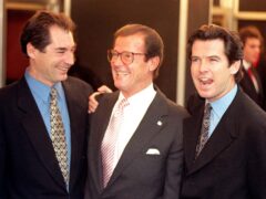 James Bond actors Timothy Dalton, left, Sir Roger Moore, centre, and Pierce Brosnan pictured in 1996 (Fiona Hanson/PA)
