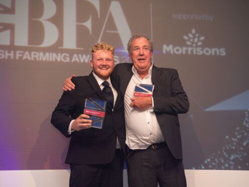 Kaleb Cooper and Jeremy Clarkson with their award (Amazon Prime Video Clarkson’s Farm/PA)