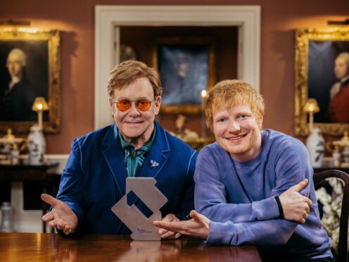 Ed Sheeran and Sir Elton John with their Official Charts Company award for Merry Christmas reaching number one (Official Charts Company/PA)