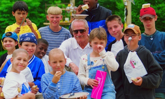 Paul Newman with children at one of his charity's camps in the USA